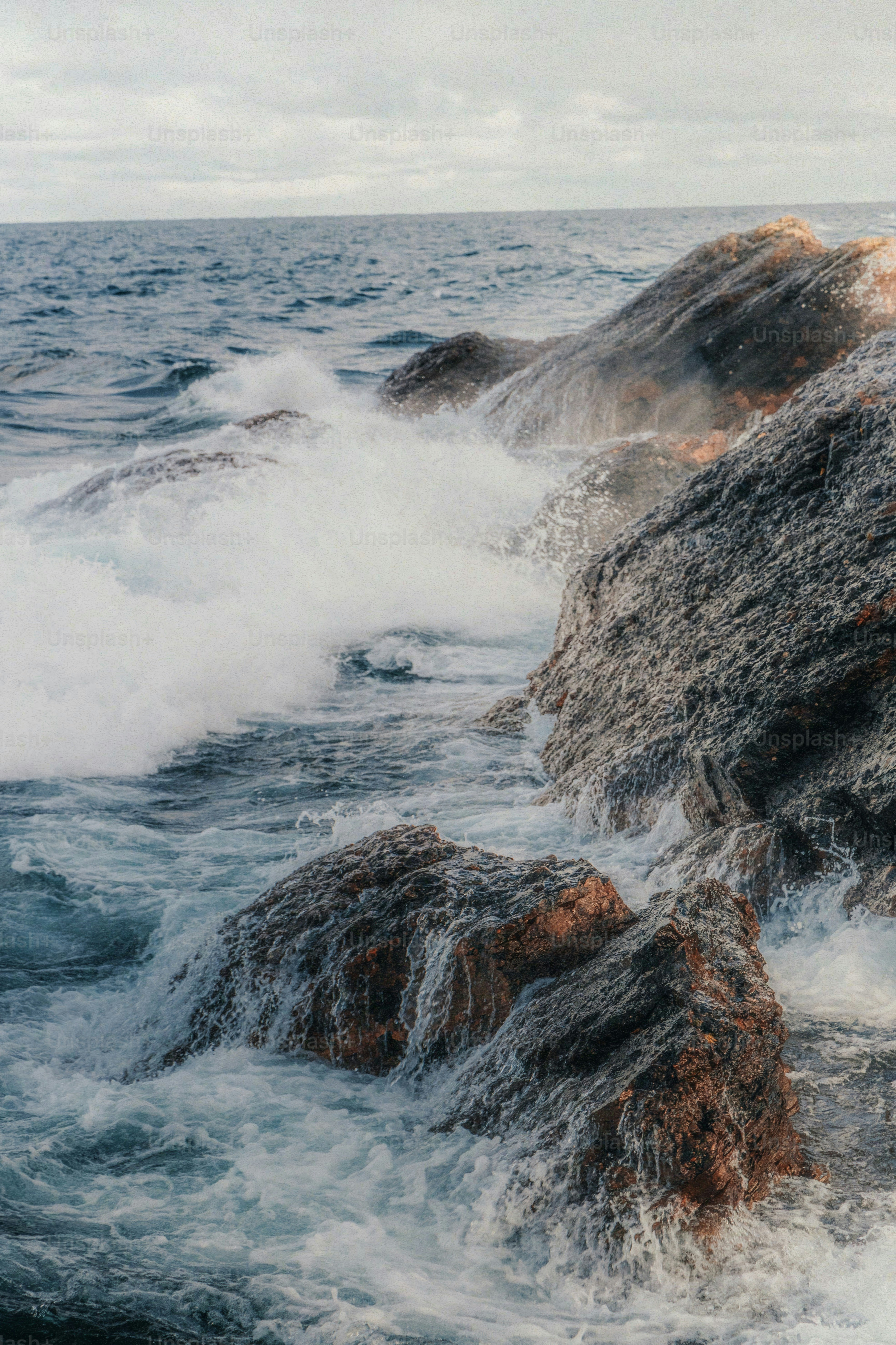 waves crashing against a rock