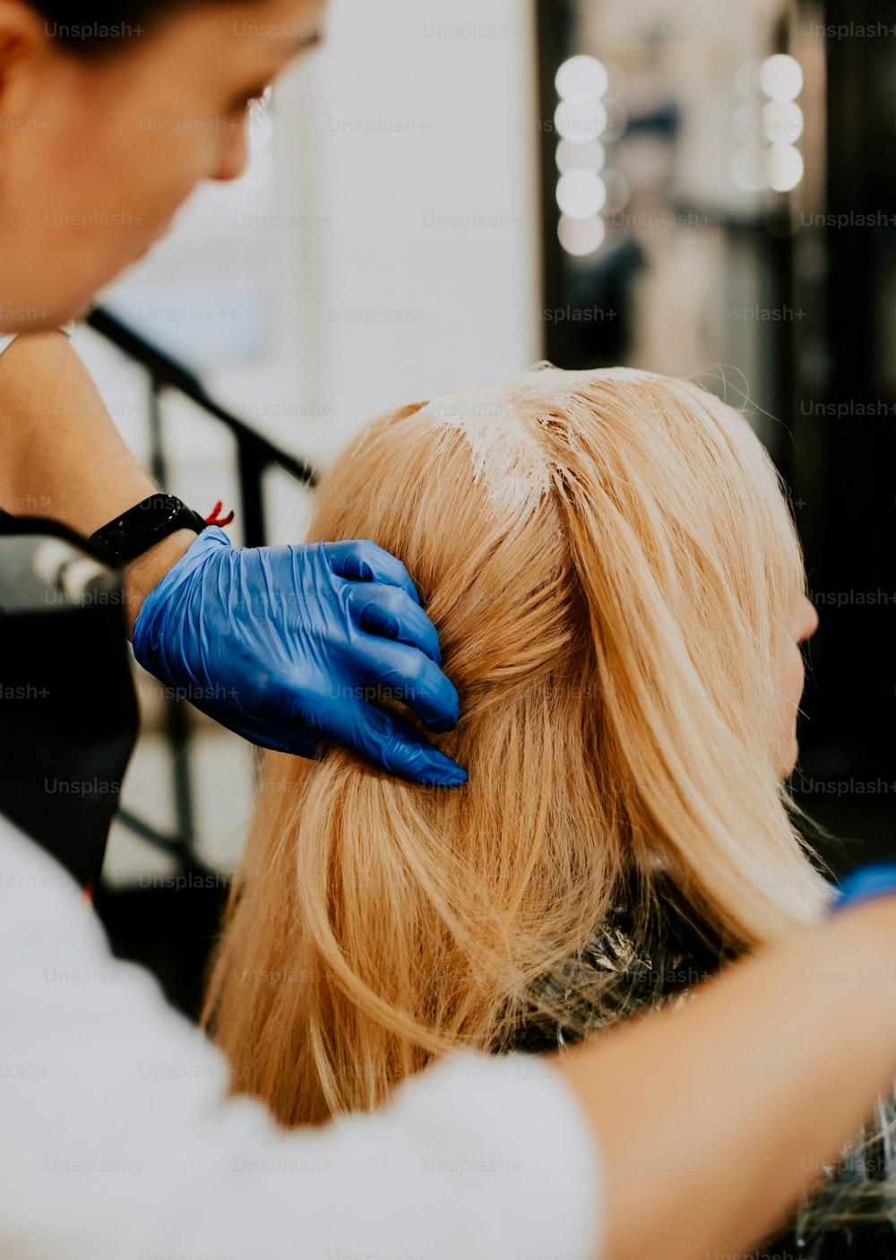 a woman getting her hair cut by a hair stylist