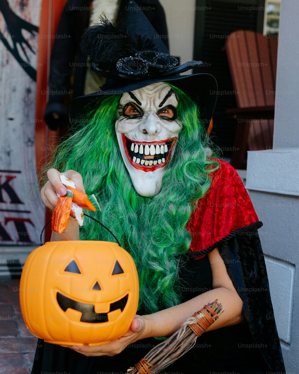 a person in a garment holding a pumpkin