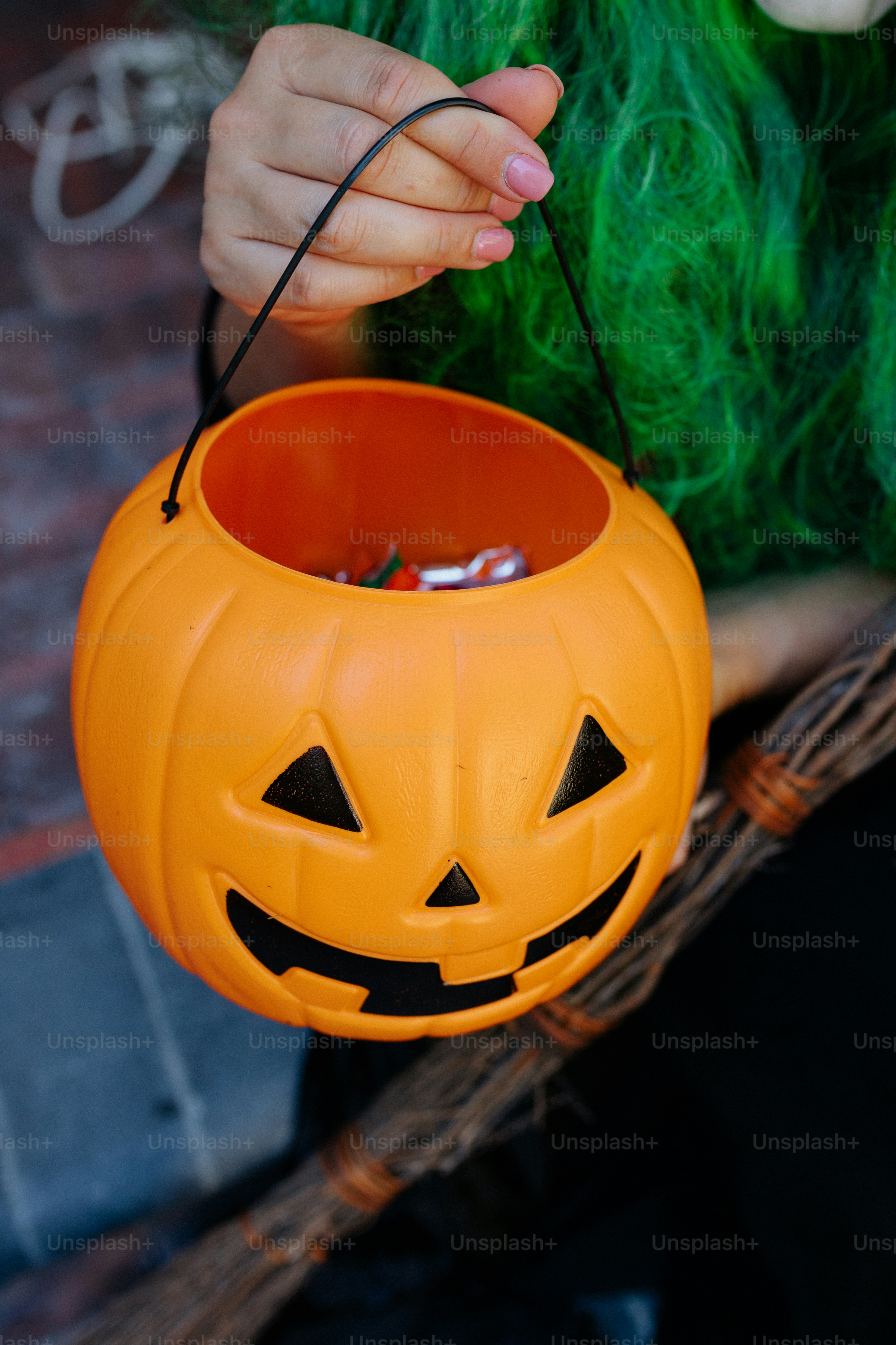 a hand holding a pumpkin
