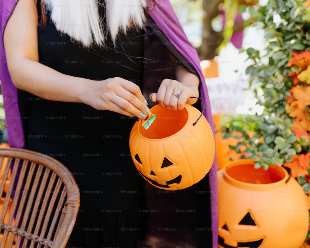 a woman carving a pumpkin