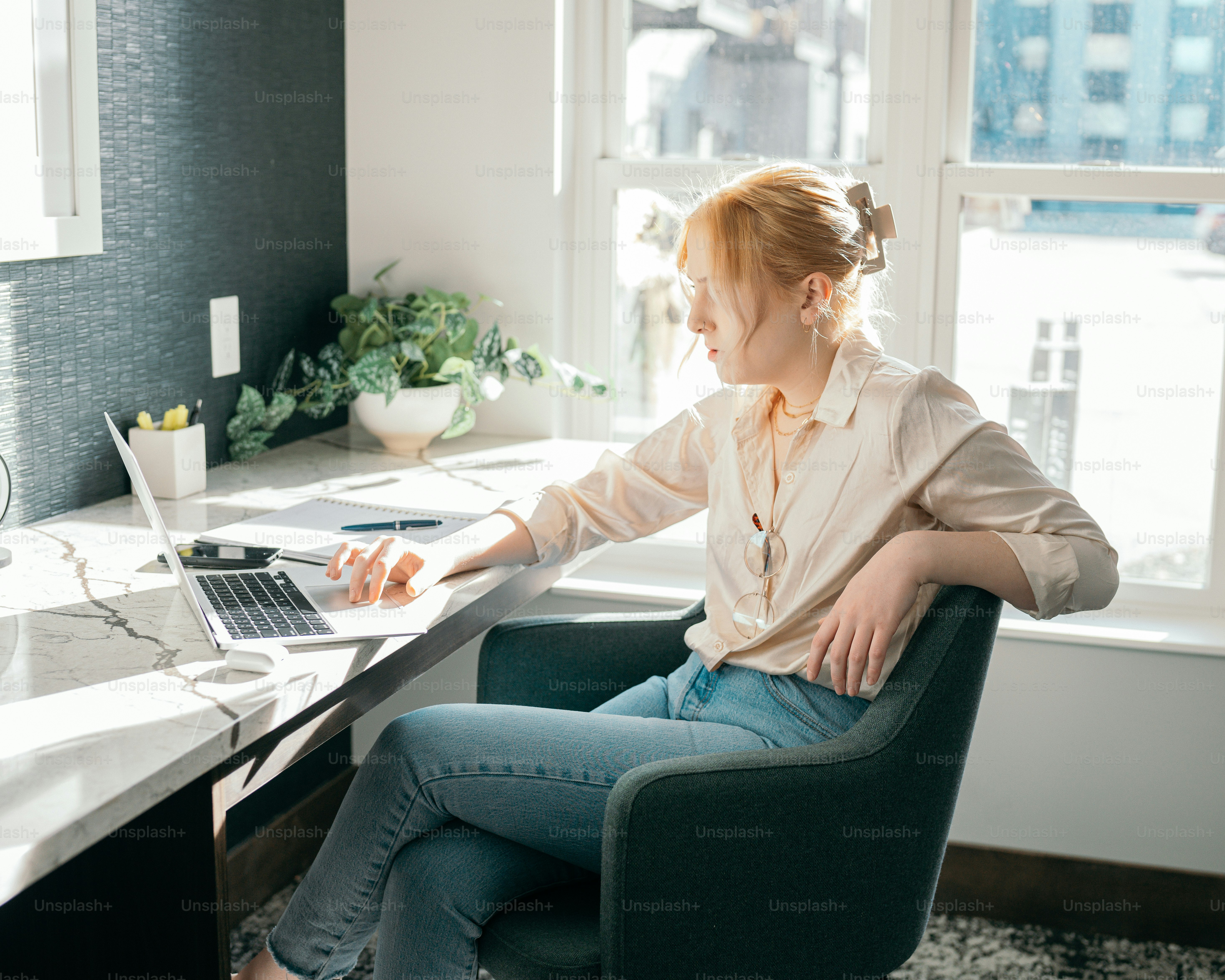 a woman sitting at a table using a laptop