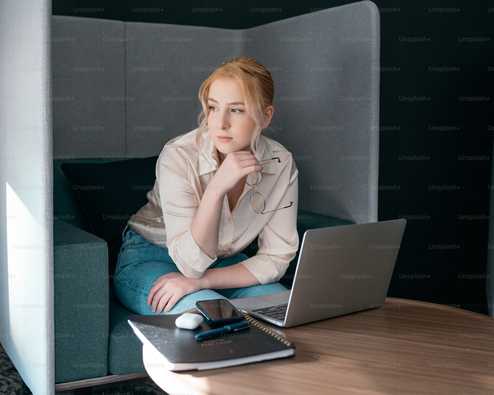 una persona seduta a un tavolo con un computer portatile