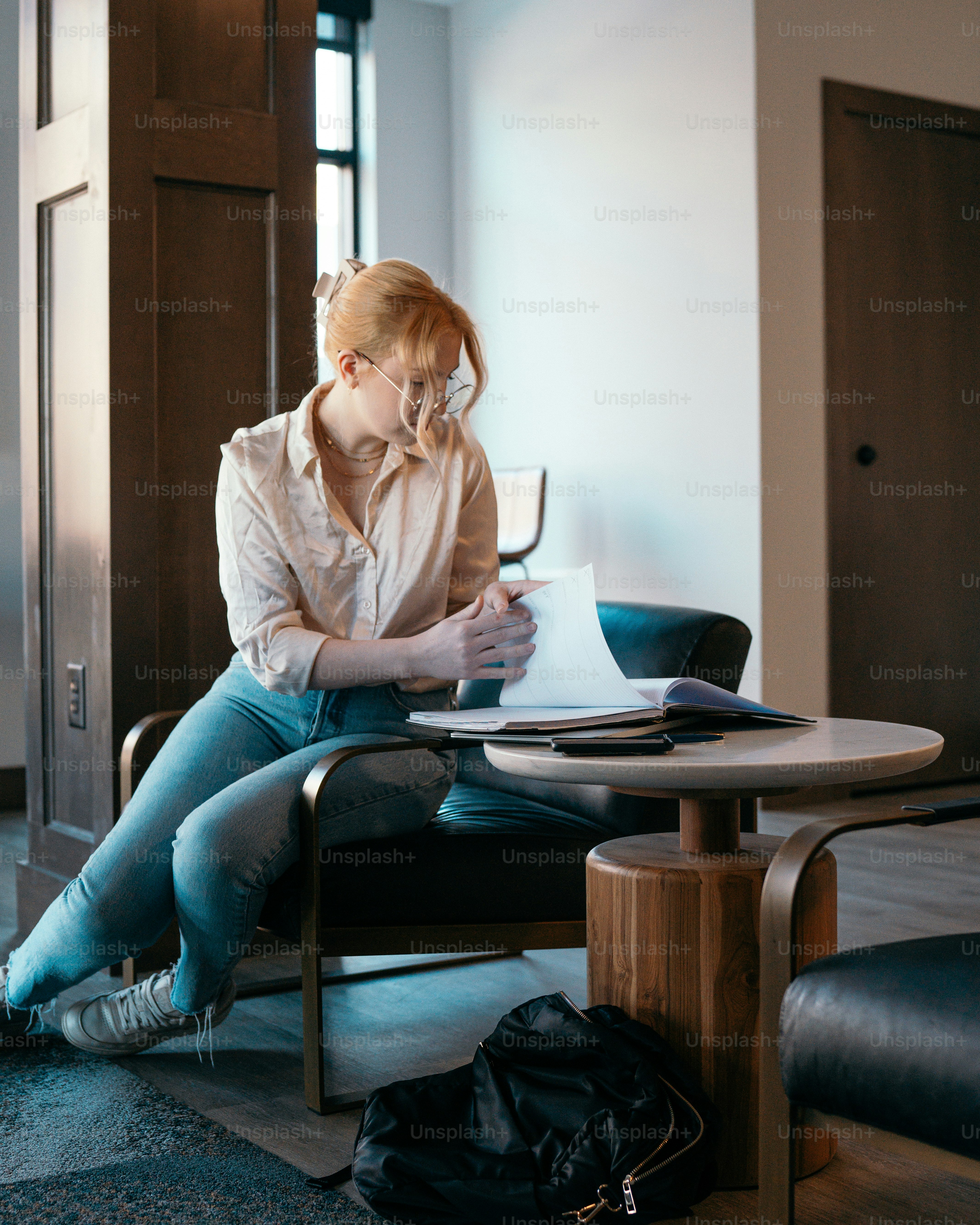 a woman sitting at a table with a laptop