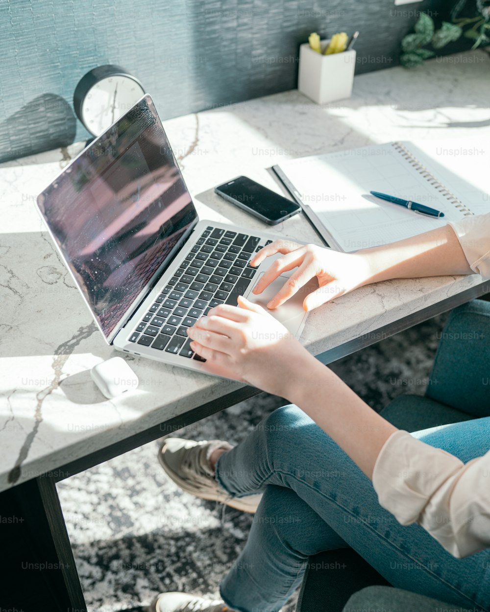 a person sitting on the ground with a laptop and papers