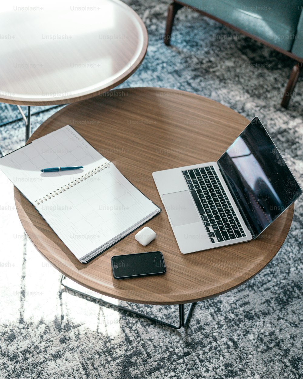 a laptop and a pen on a table