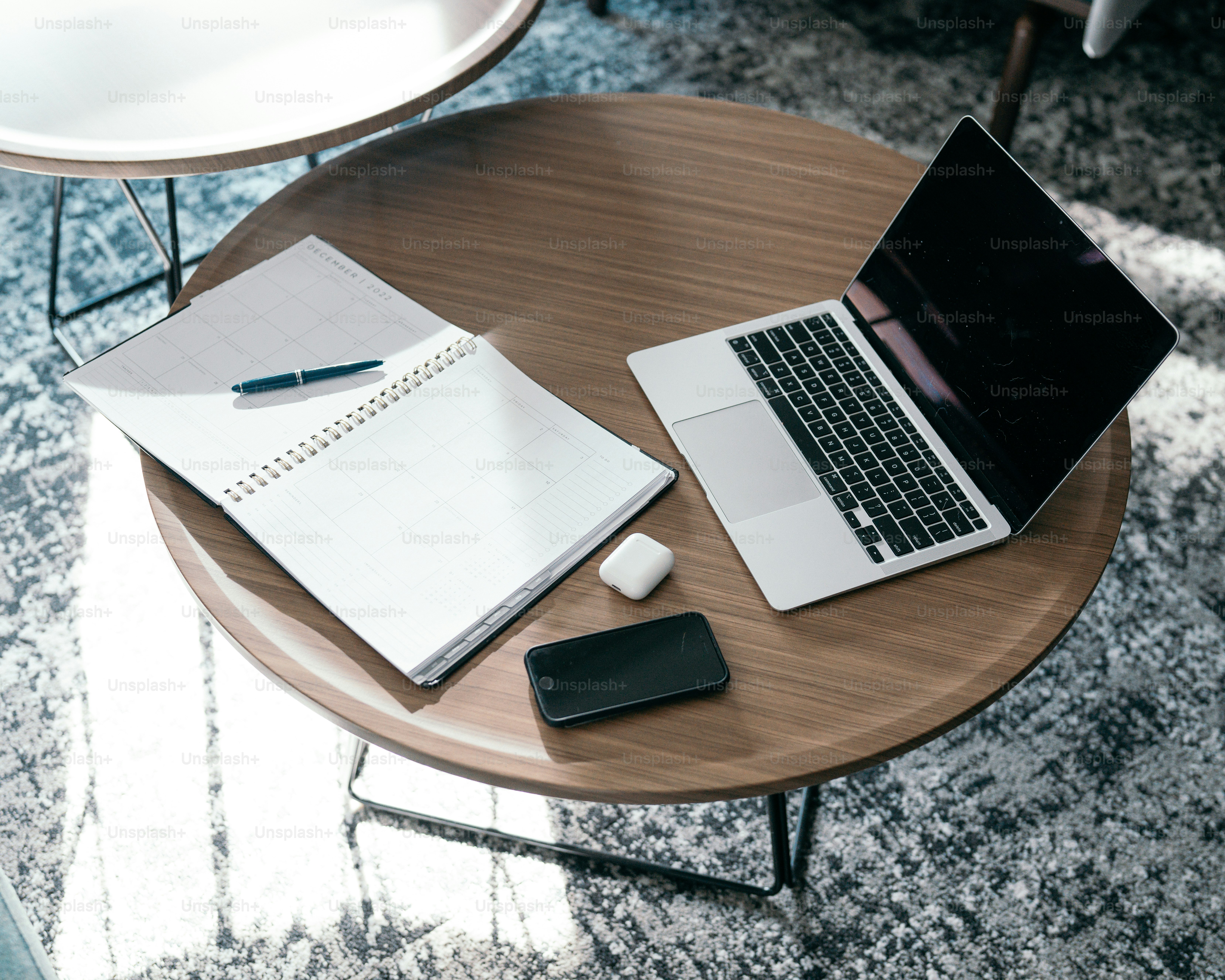 a laptop and a pen on a table