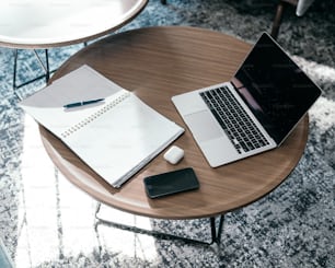 a laptop and a pen on a table