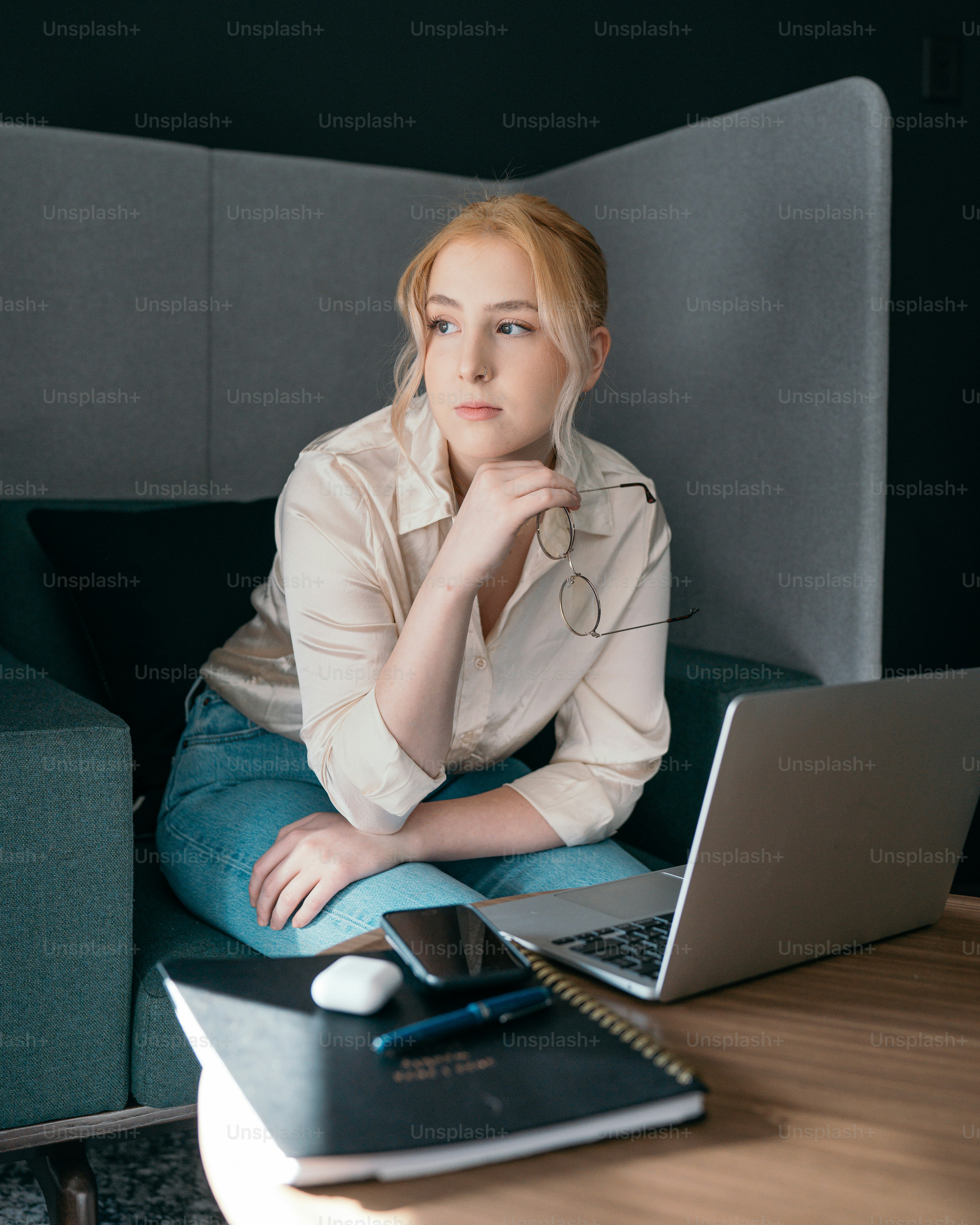 a person sitting at a table with a laptop