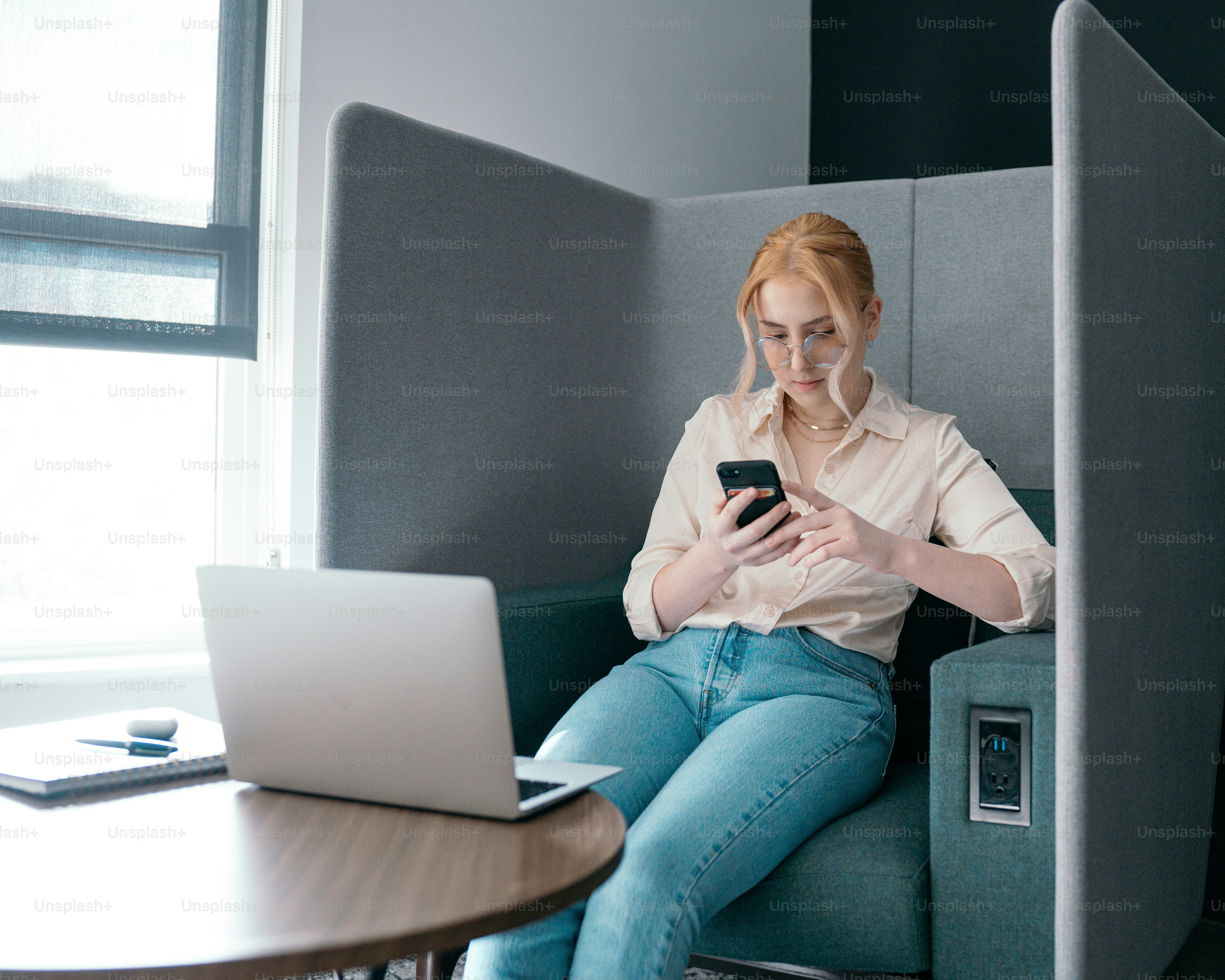 a person sitting on a chair looking at the phone