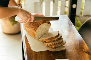 a person cutting a sandwich