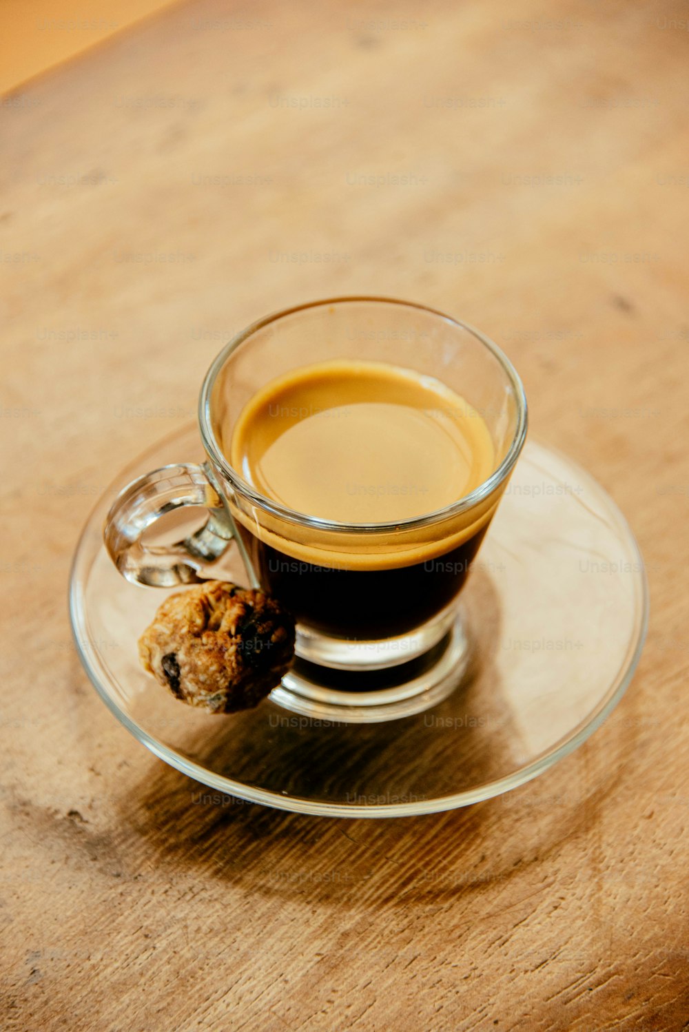 a cup of coffee and a cookie on a saucer