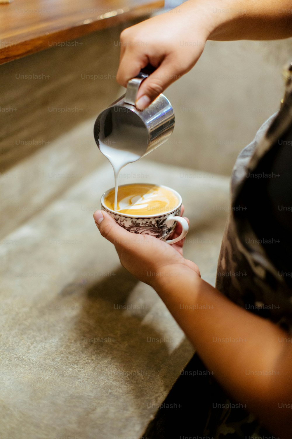 a person pouring a liquid into a cup