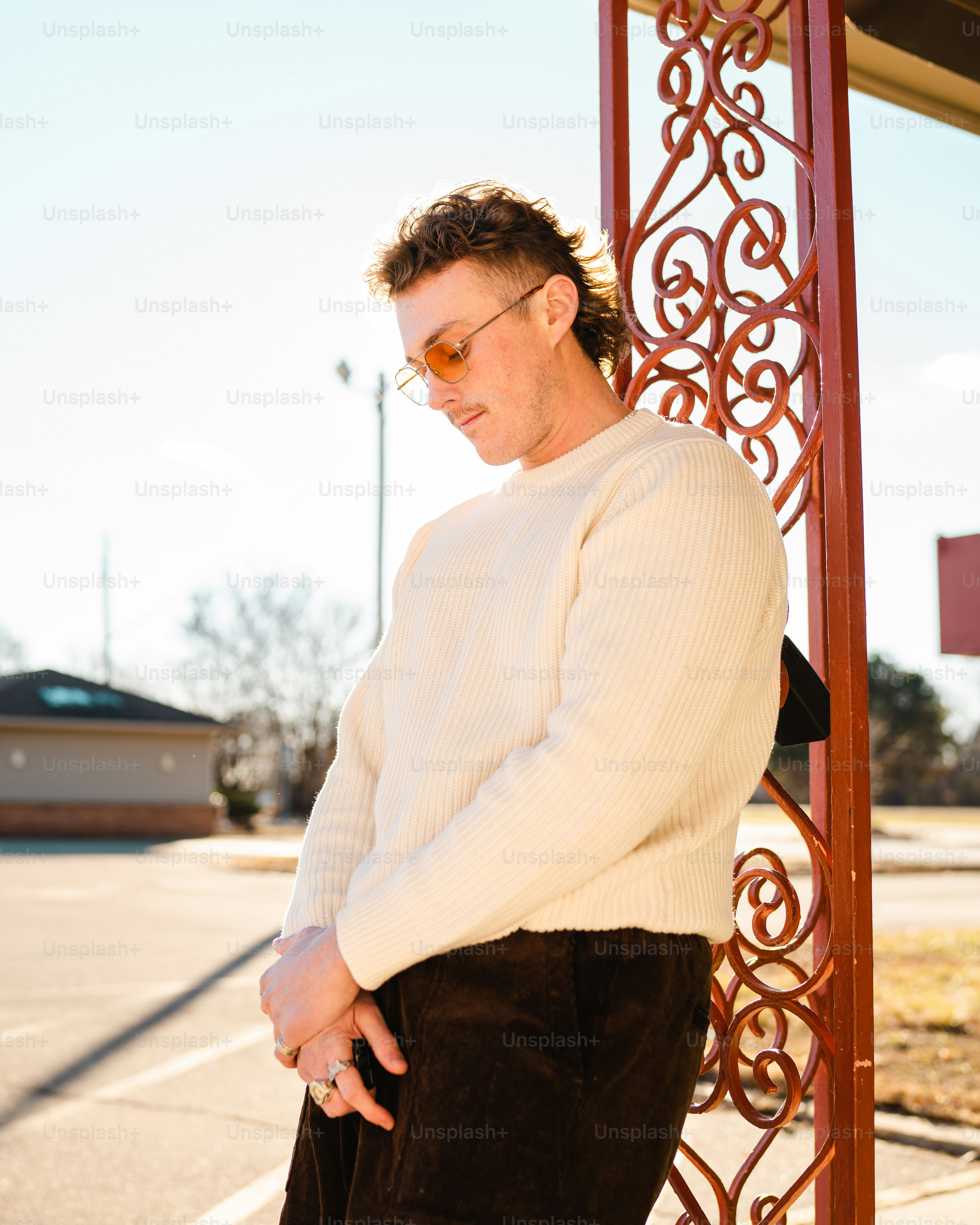 a man standing in front of a red gate