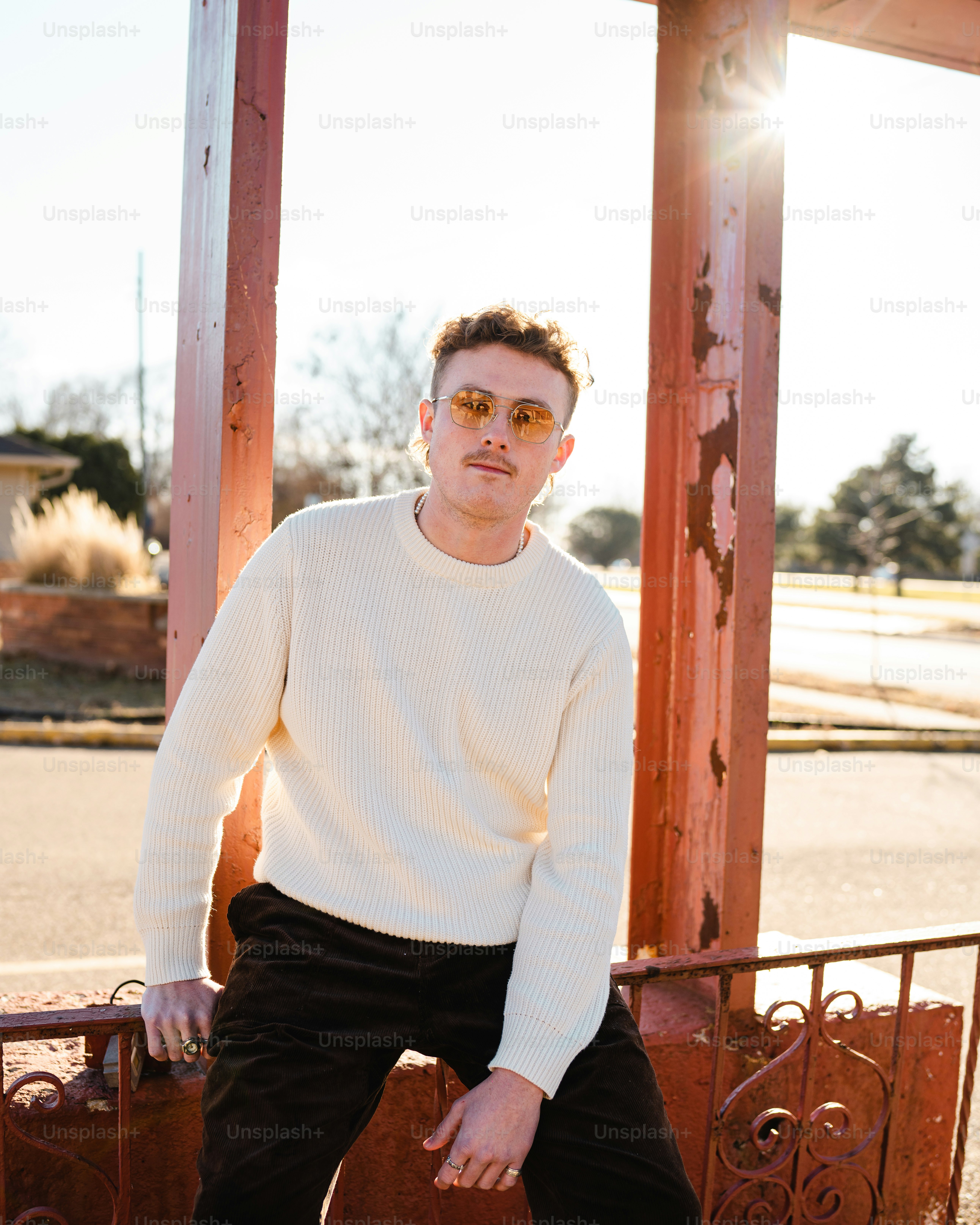a man sitting on a railing