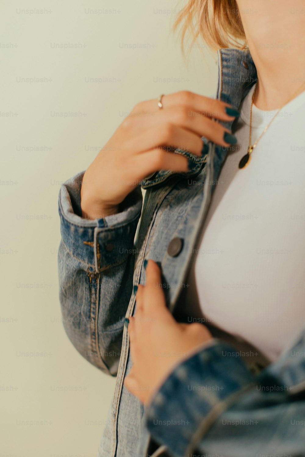 a woman holding a pair of jeans