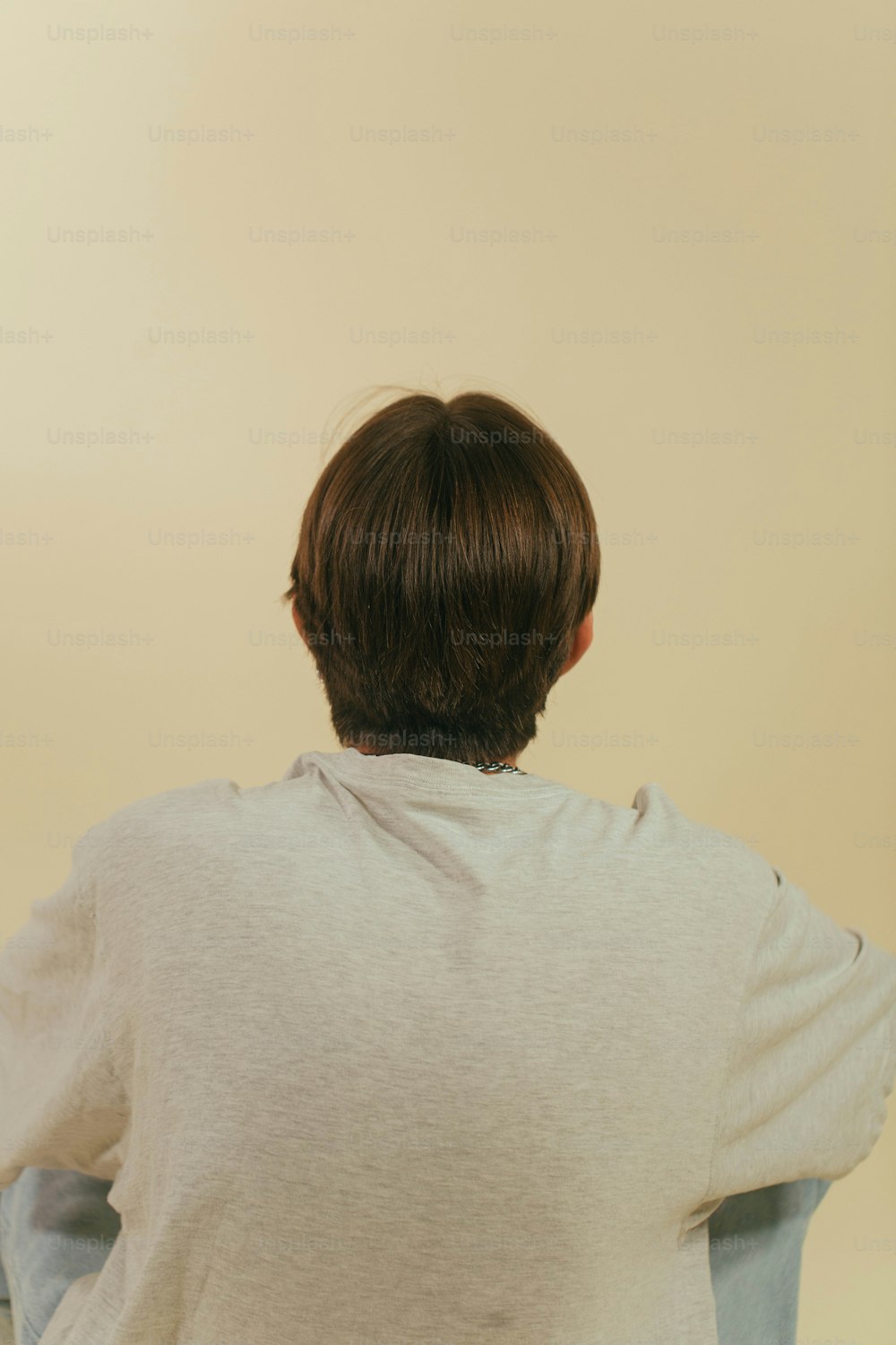 a person sitting on a chair with their back to the camera