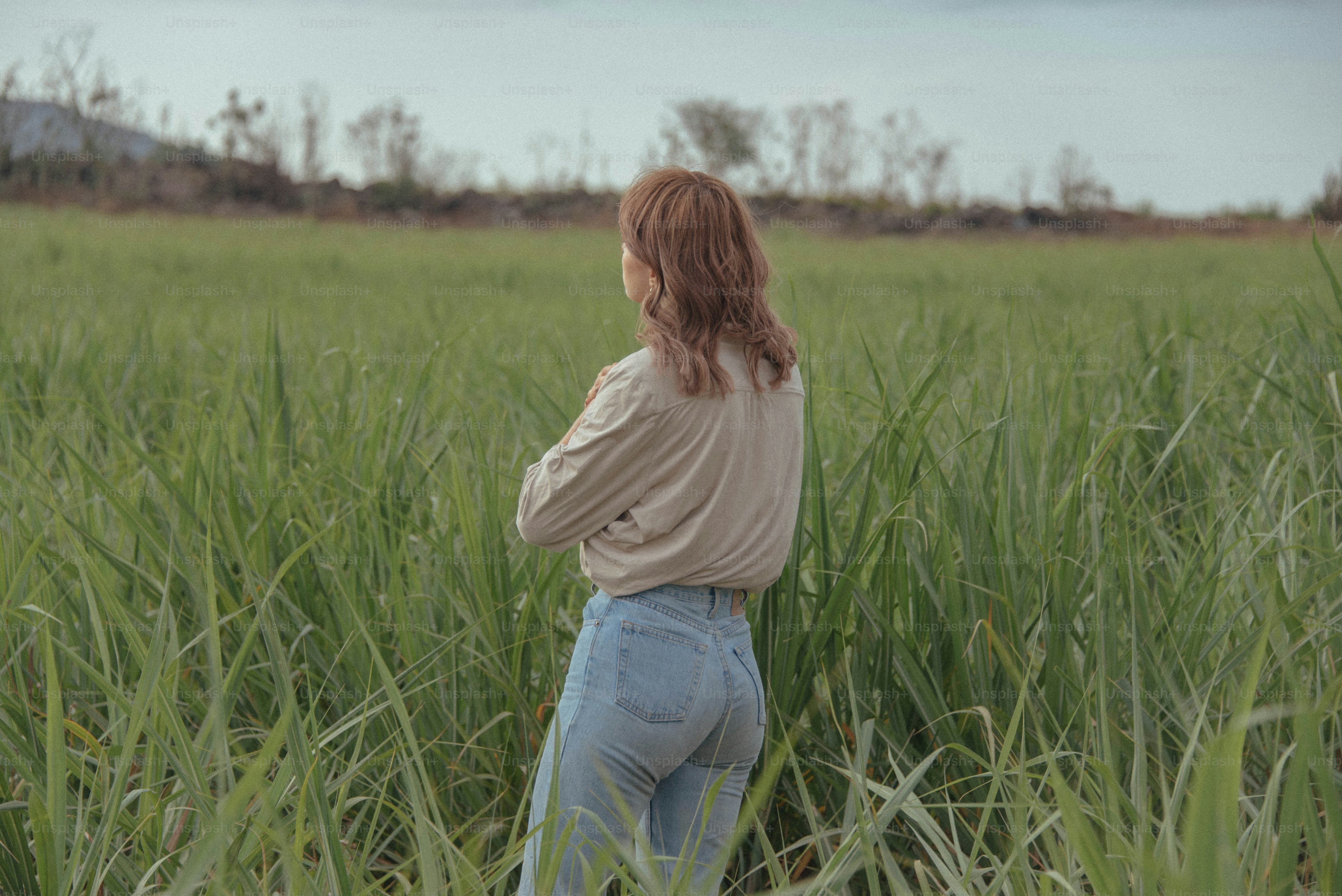 a man standing in a field of tall grass