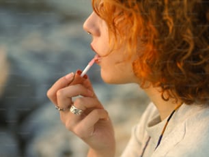 a woman lighting a cigarette