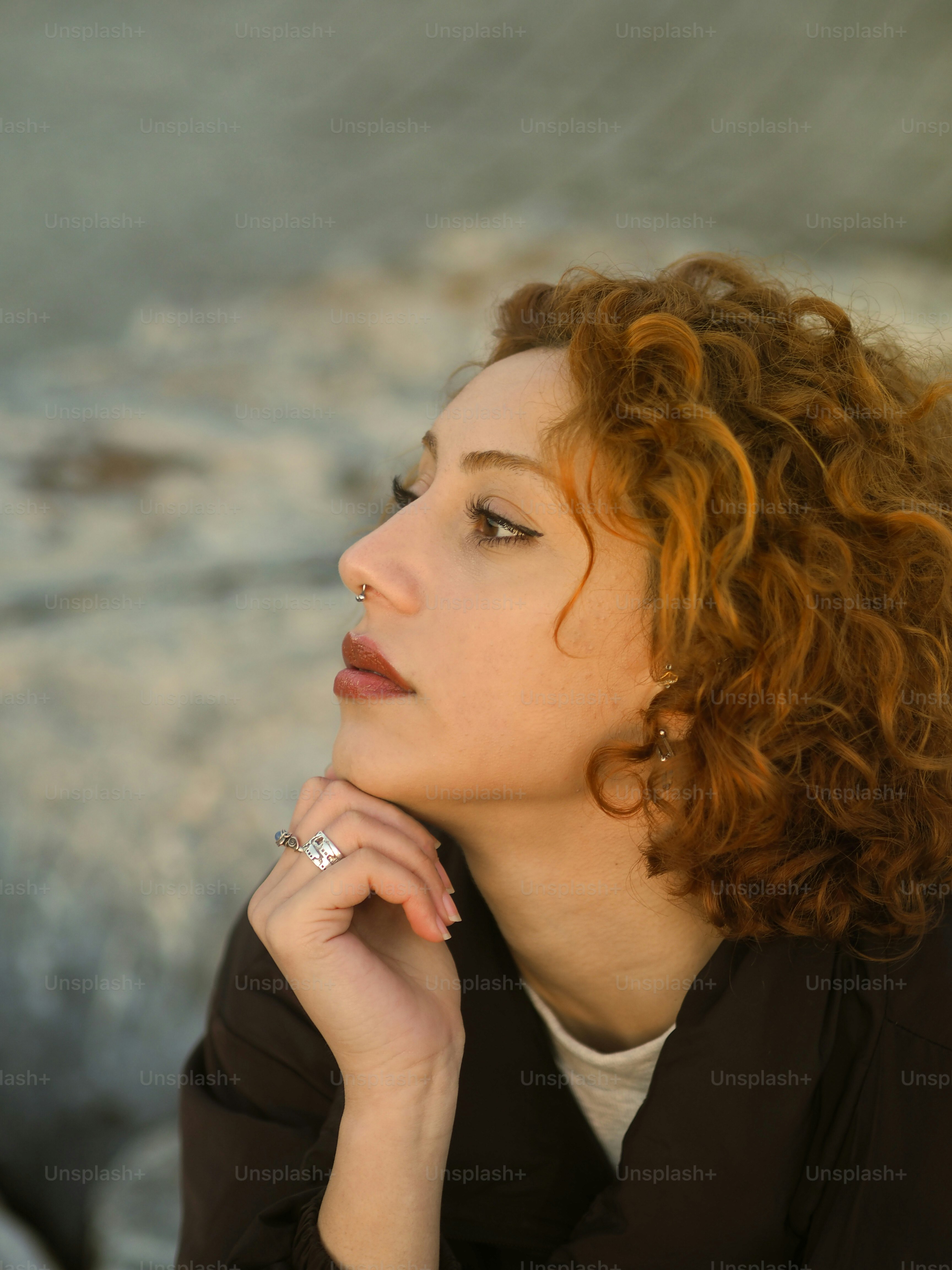 a woman with her hand on her chin