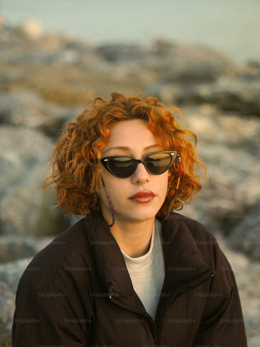 a woman with red hair wearing sunglasses