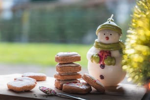 a small figurine next to a pile of cookies