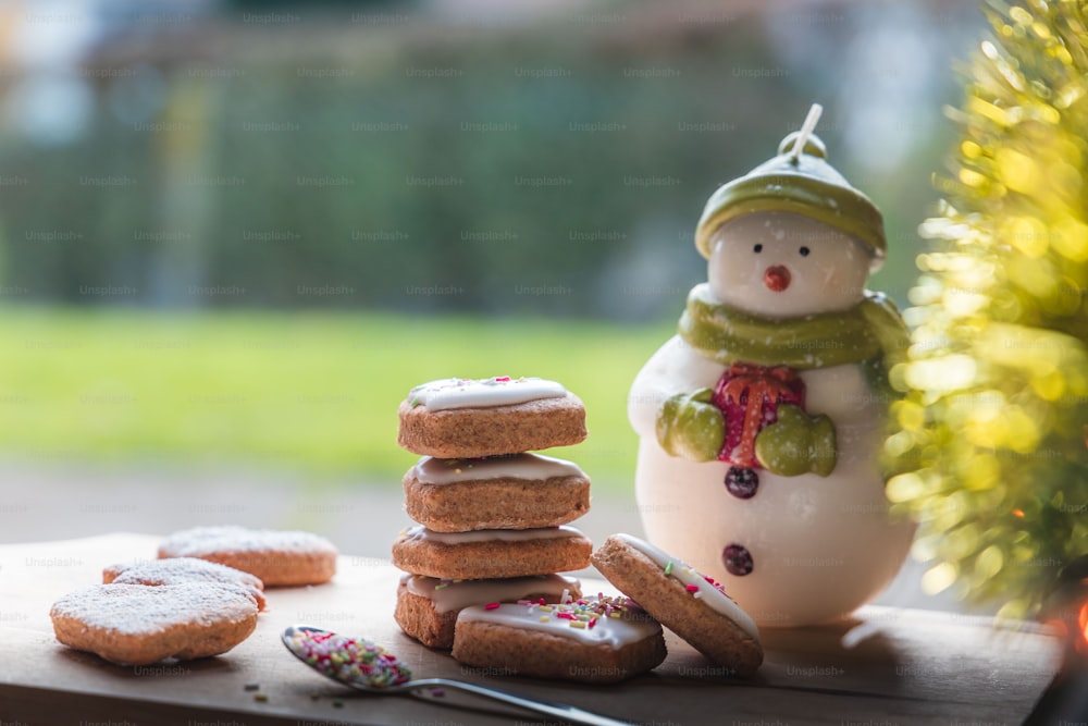 a small figurine next to a pile of cookies
