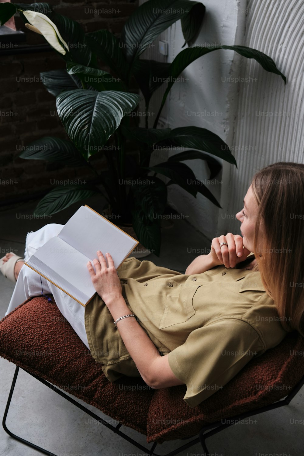 a person sitting on a couch reading a book