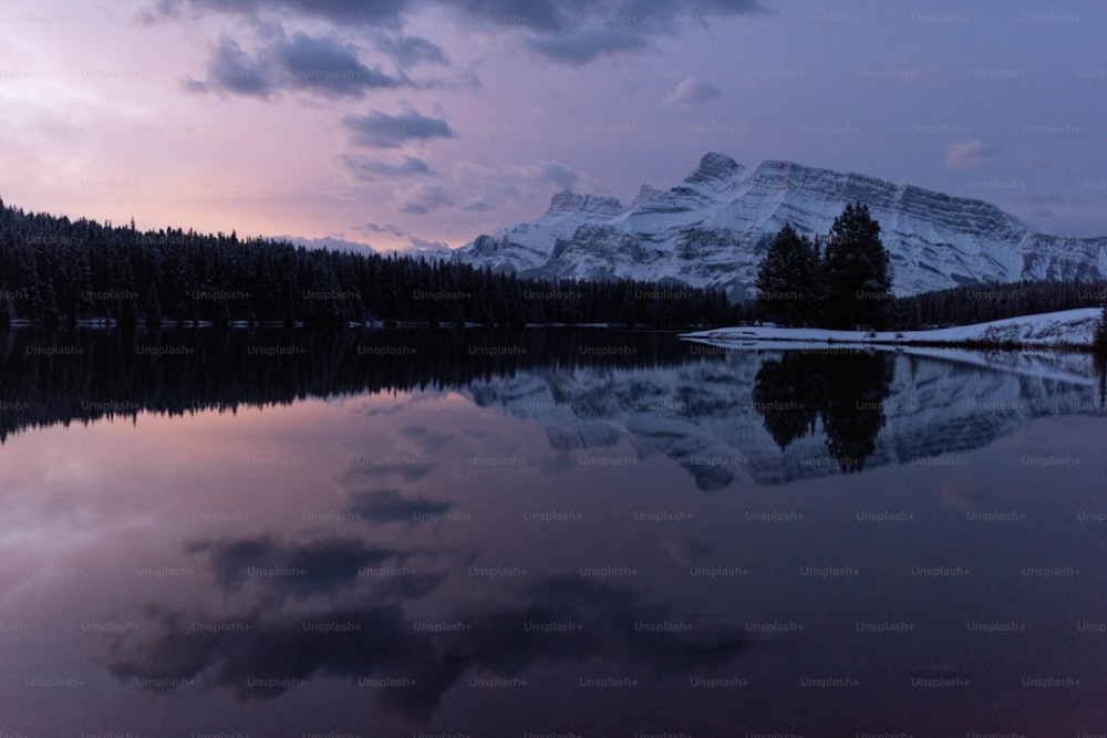 a lake with a snowy mountain in the background