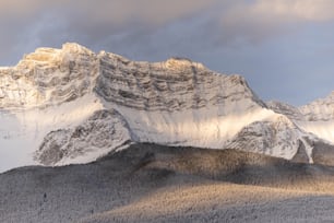 a snowy mountain with a valley below