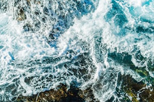 a wave crashing on a rocky shore