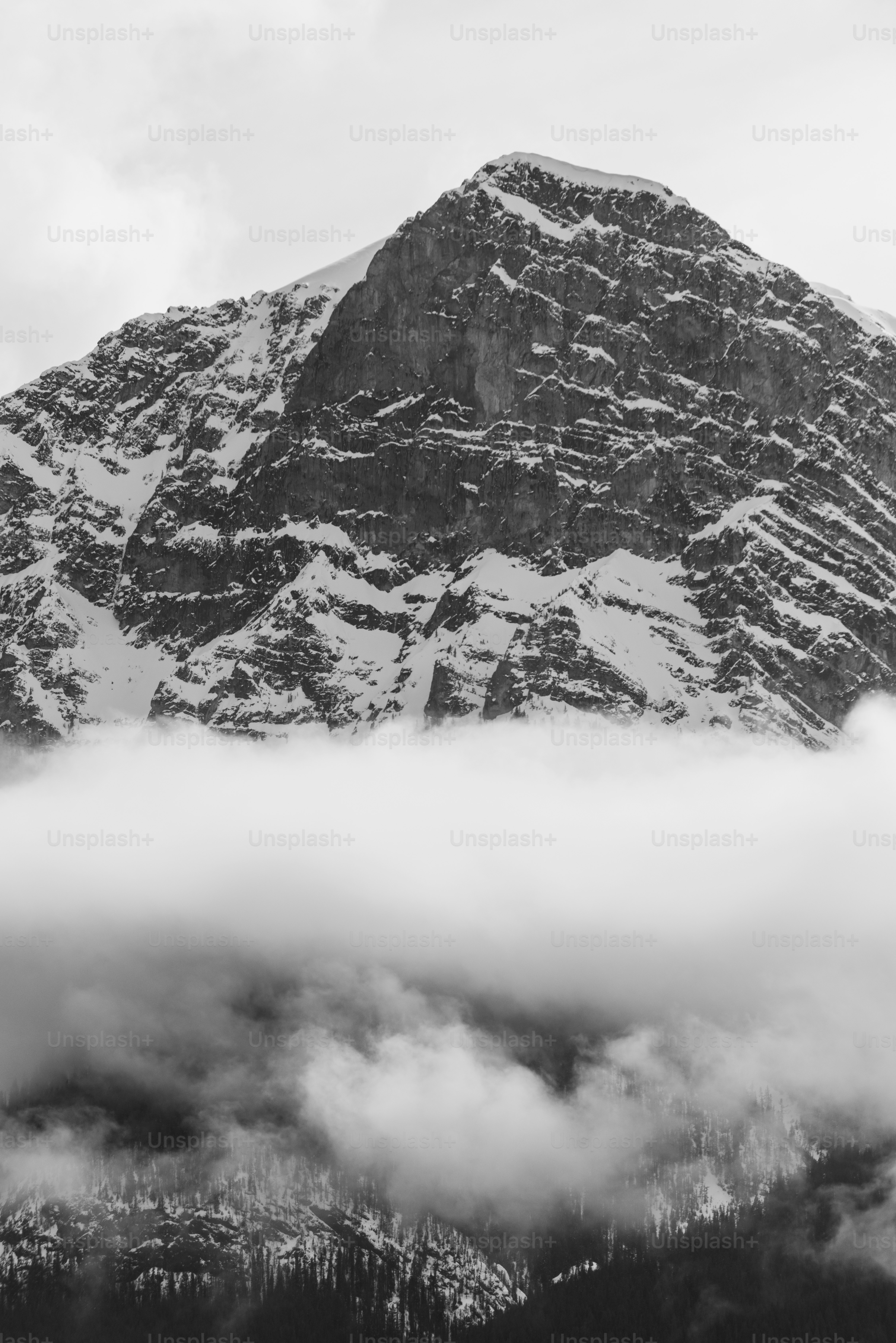 a mountain with clouds below
