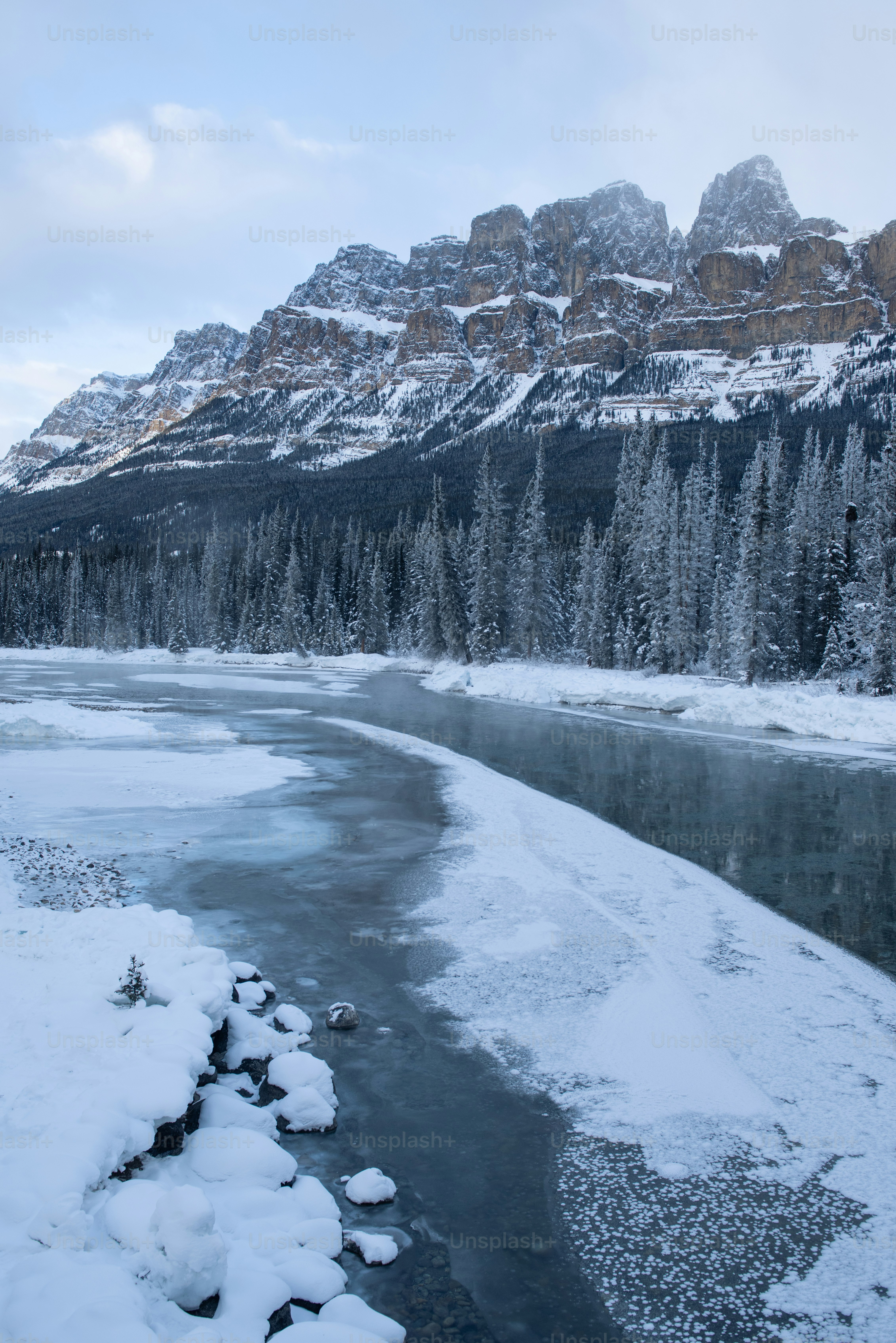a river with snow on the banks