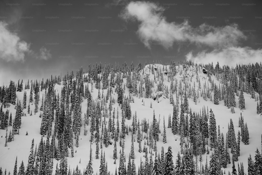 a snowy mountain with clouds