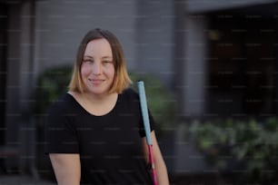 a woman smiling with a bat