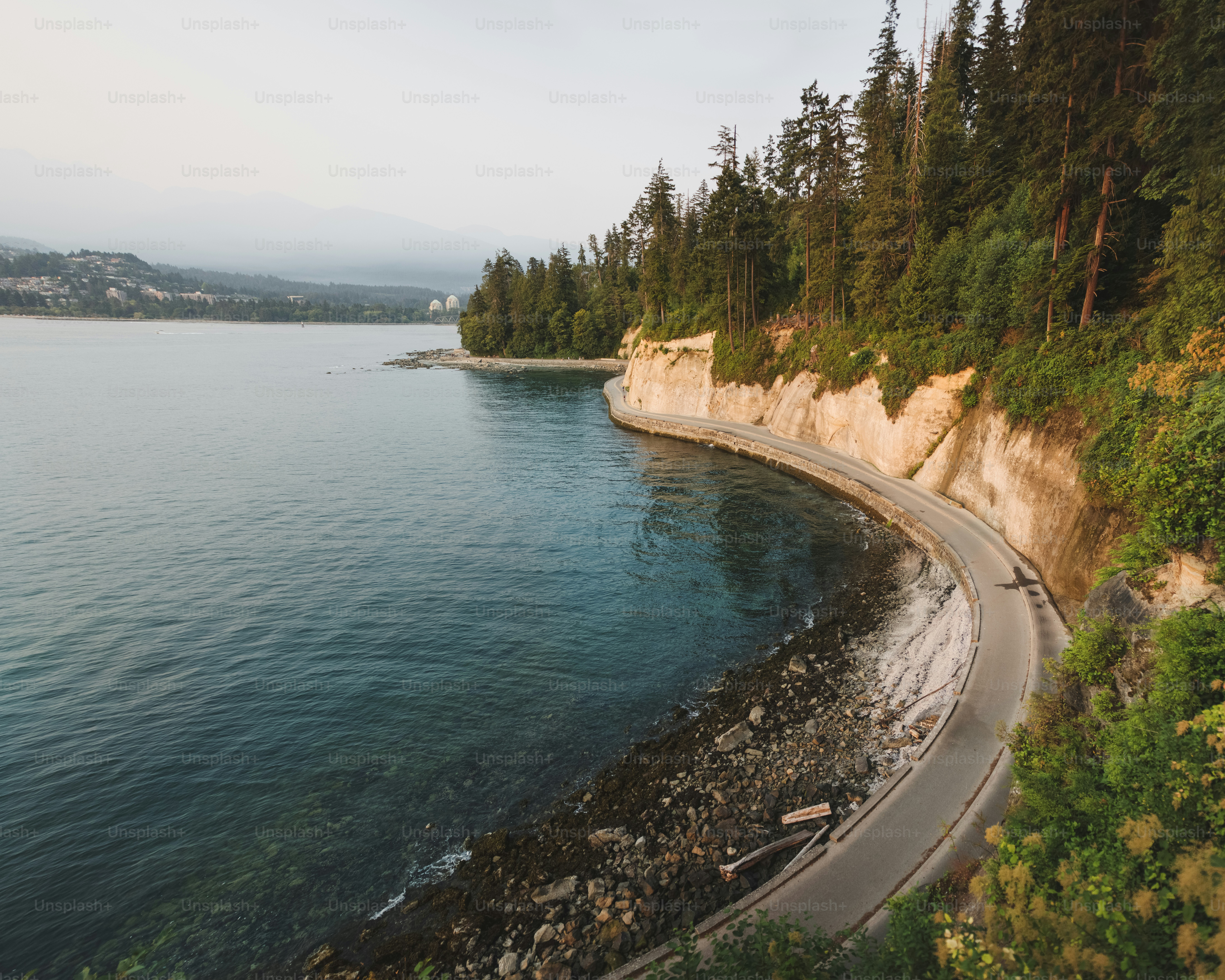 a rocky cliff next to a body of water