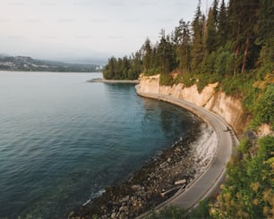 a rocky cliff next to a body of water