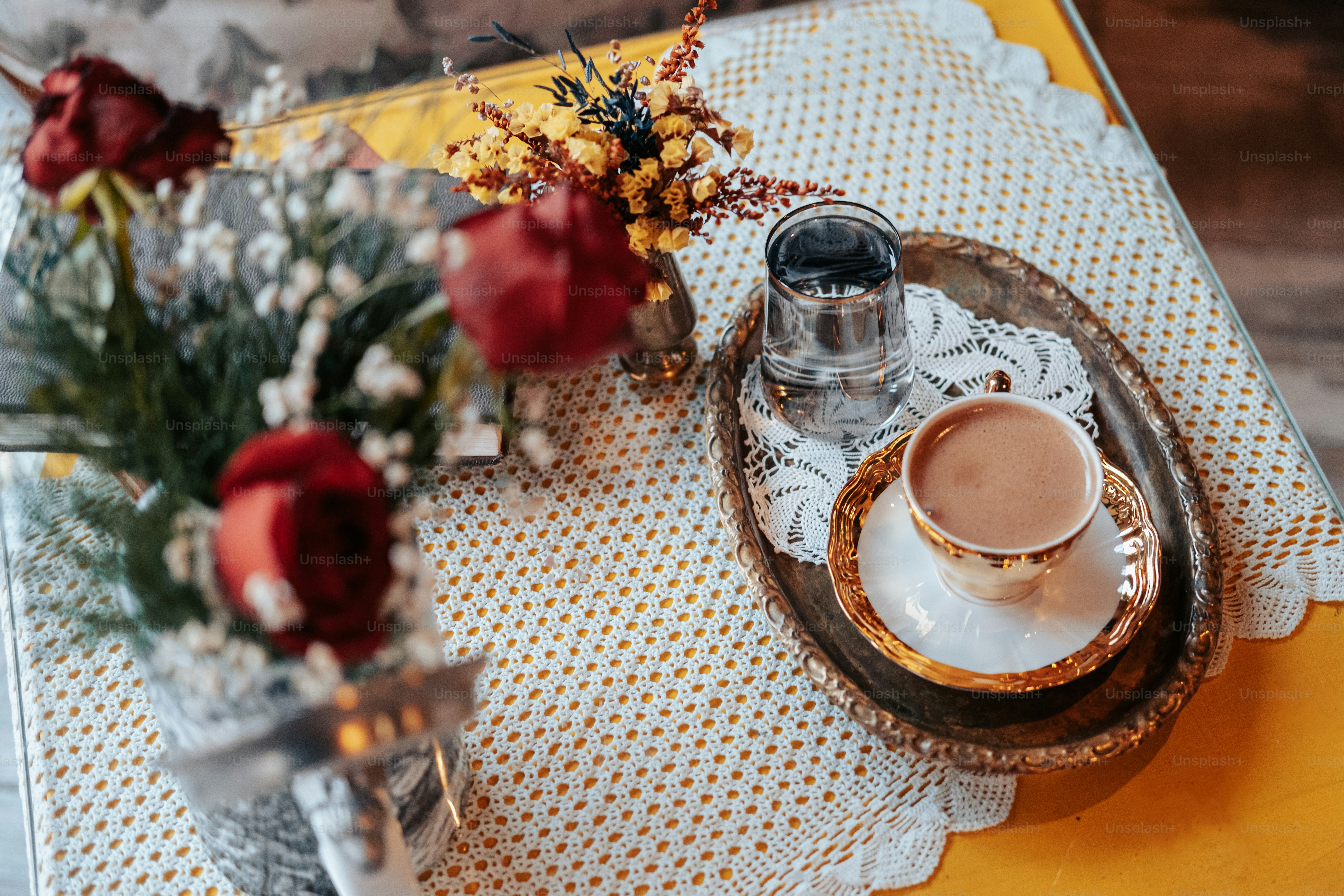 A vase with flowers and a cup of coffee on a table photo – Book Image ...