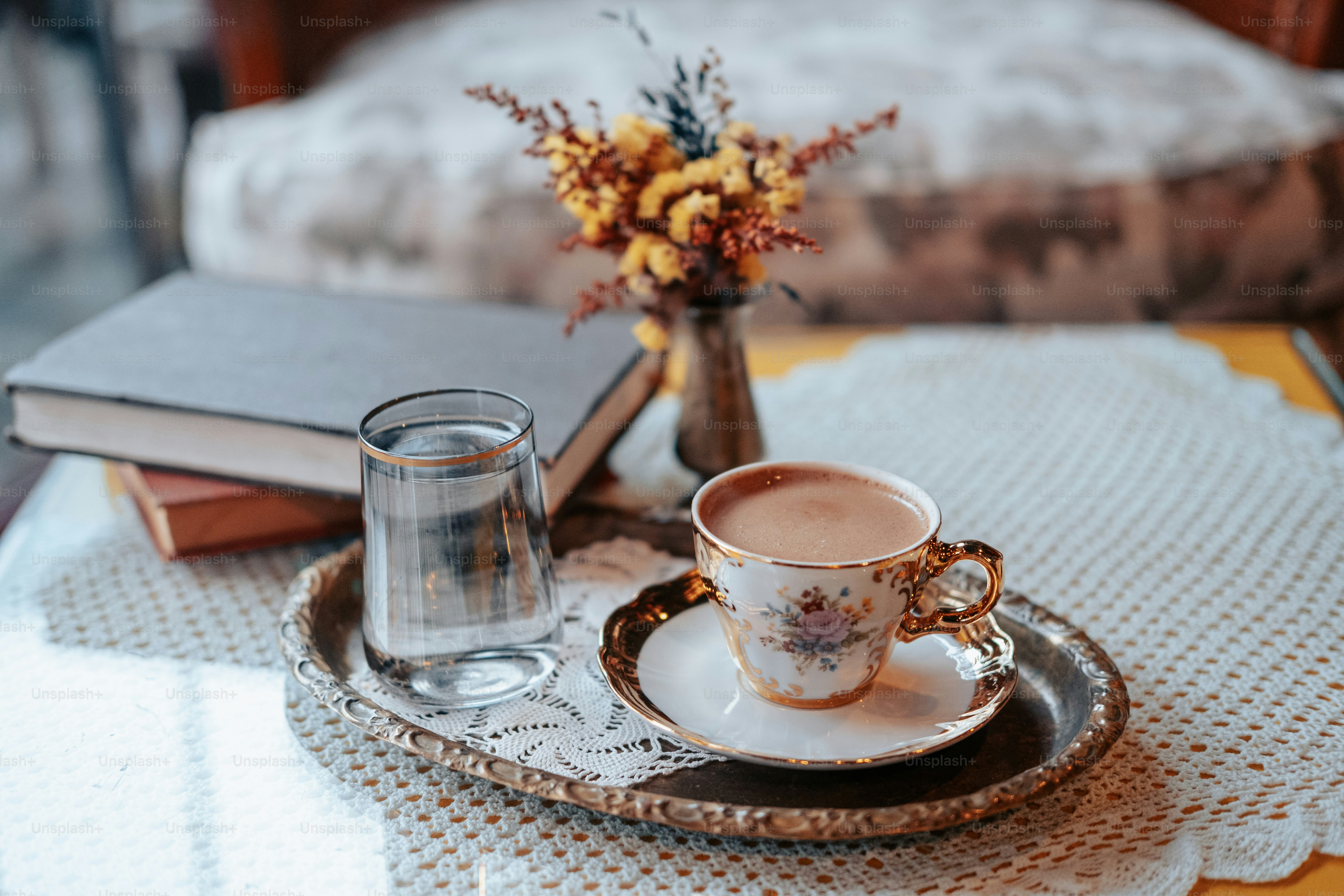 a cup of coffee and a book on a table