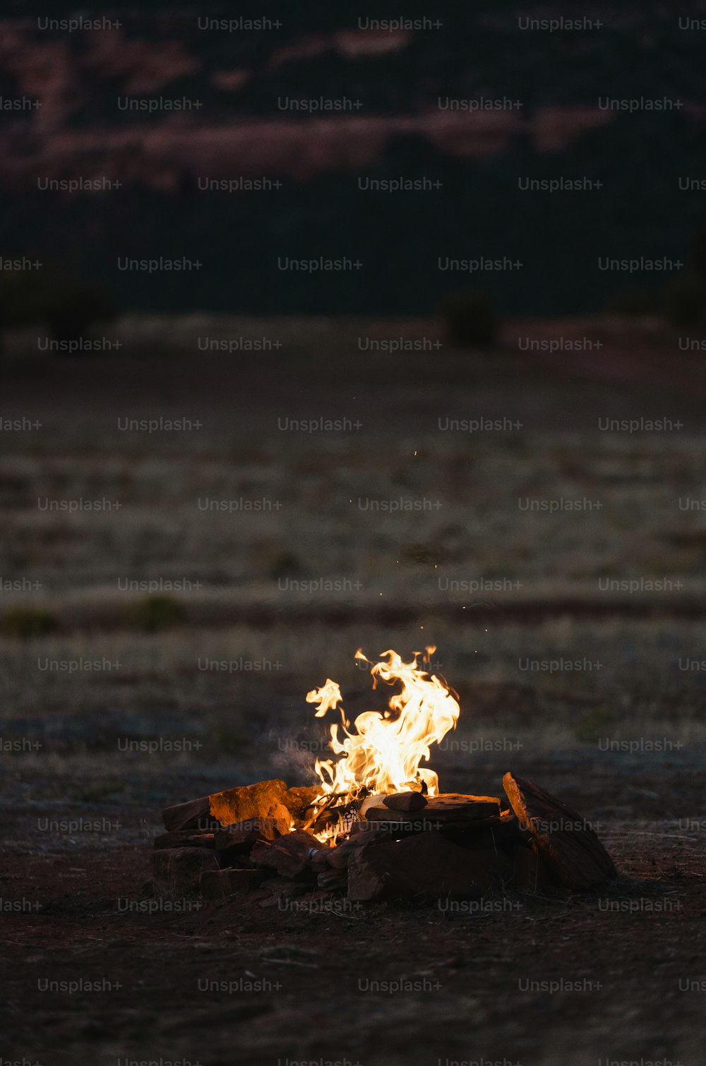 a fire burning on a rock