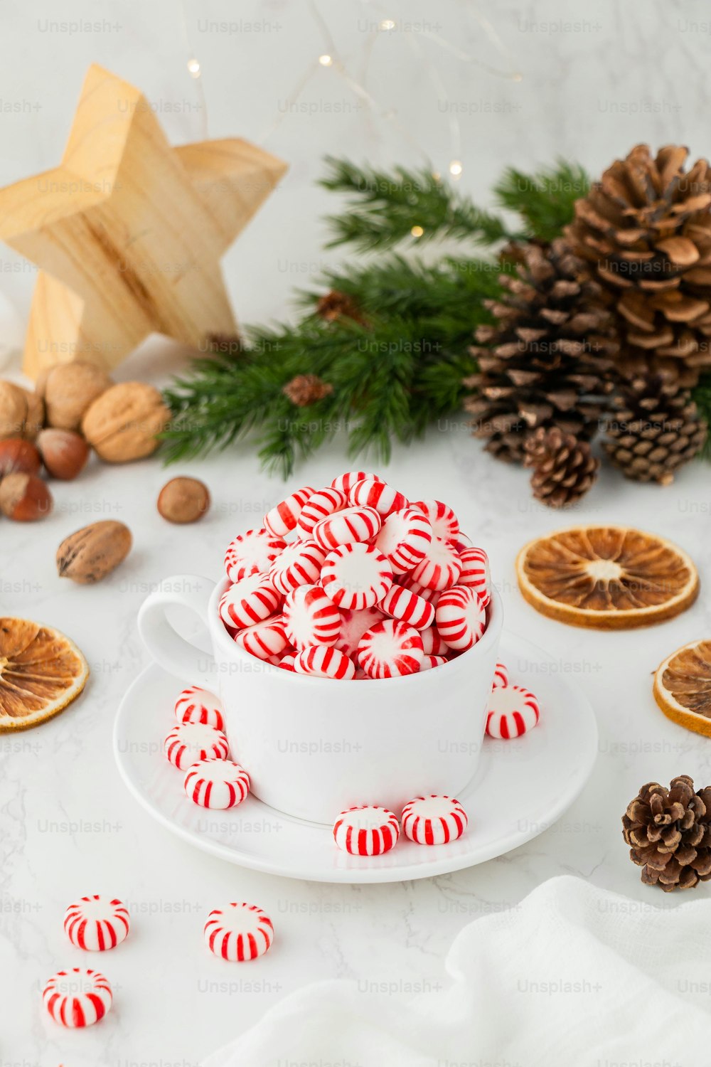 a cup of tea with a decorated tree in the background