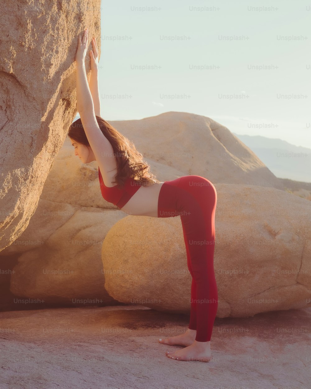 a person in red pants climbing a rock