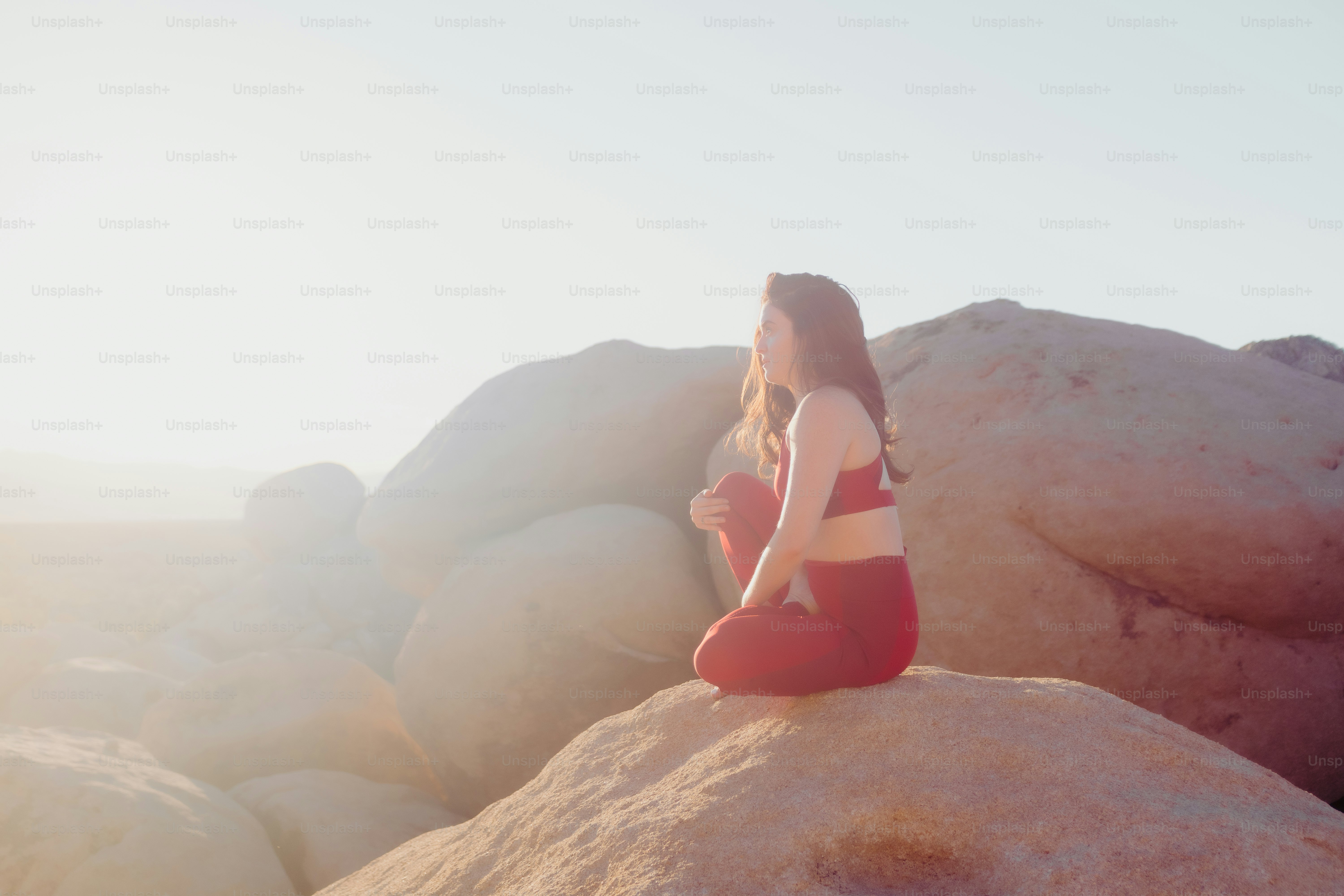a person sitting on a rock