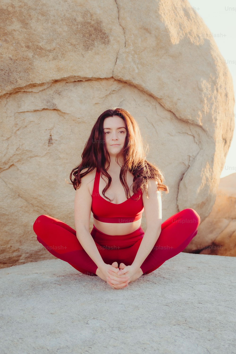 a woman sitting on a rock