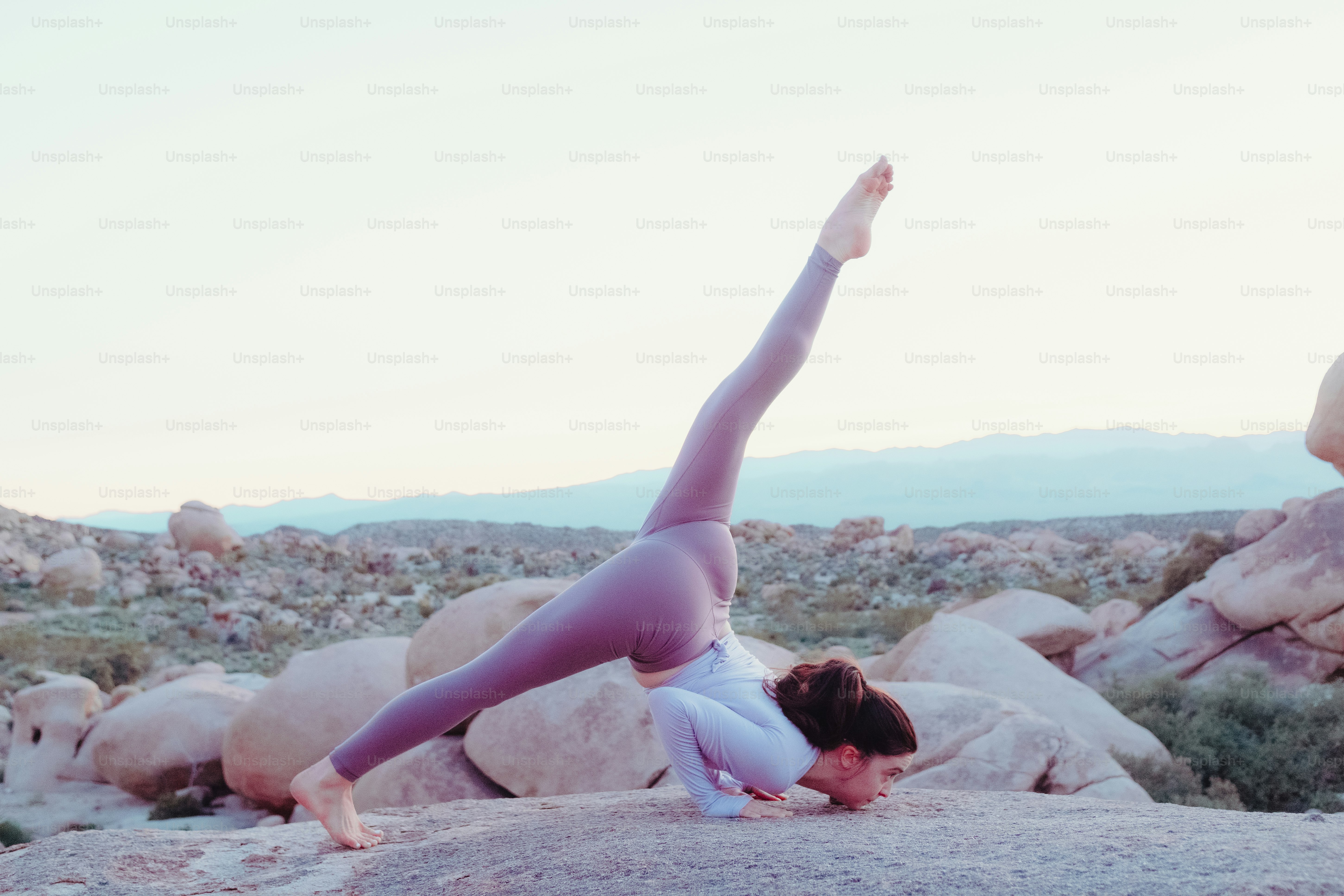 A person doing a handstand on a rock photo – Yoga Image on Unsplash