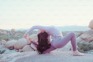 a woman lying on a rock