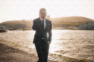 a man in a suit talking on a cell phone