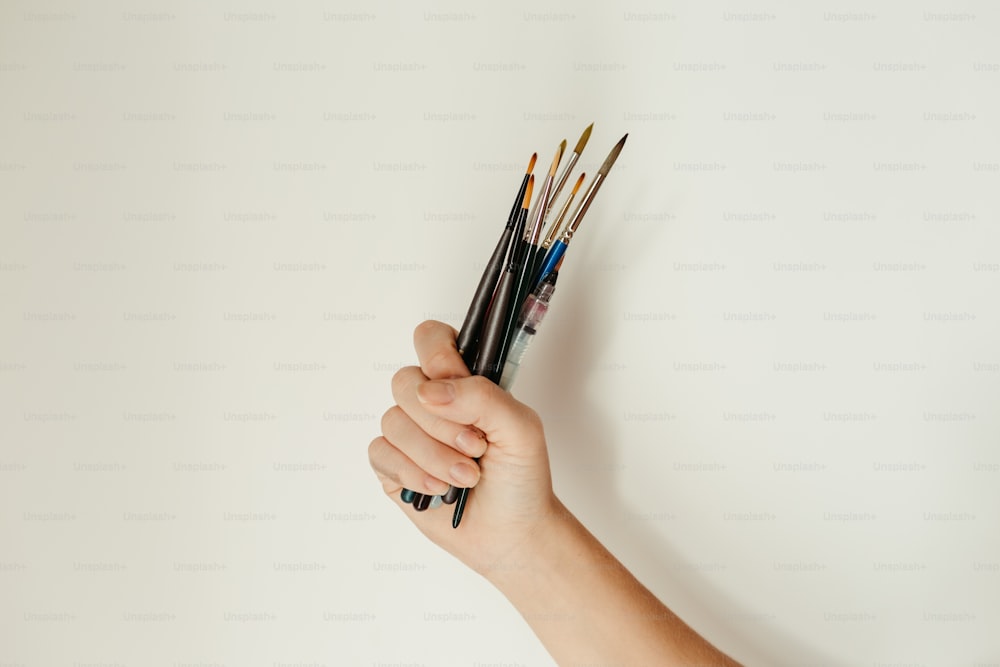 a hand holding a pencil