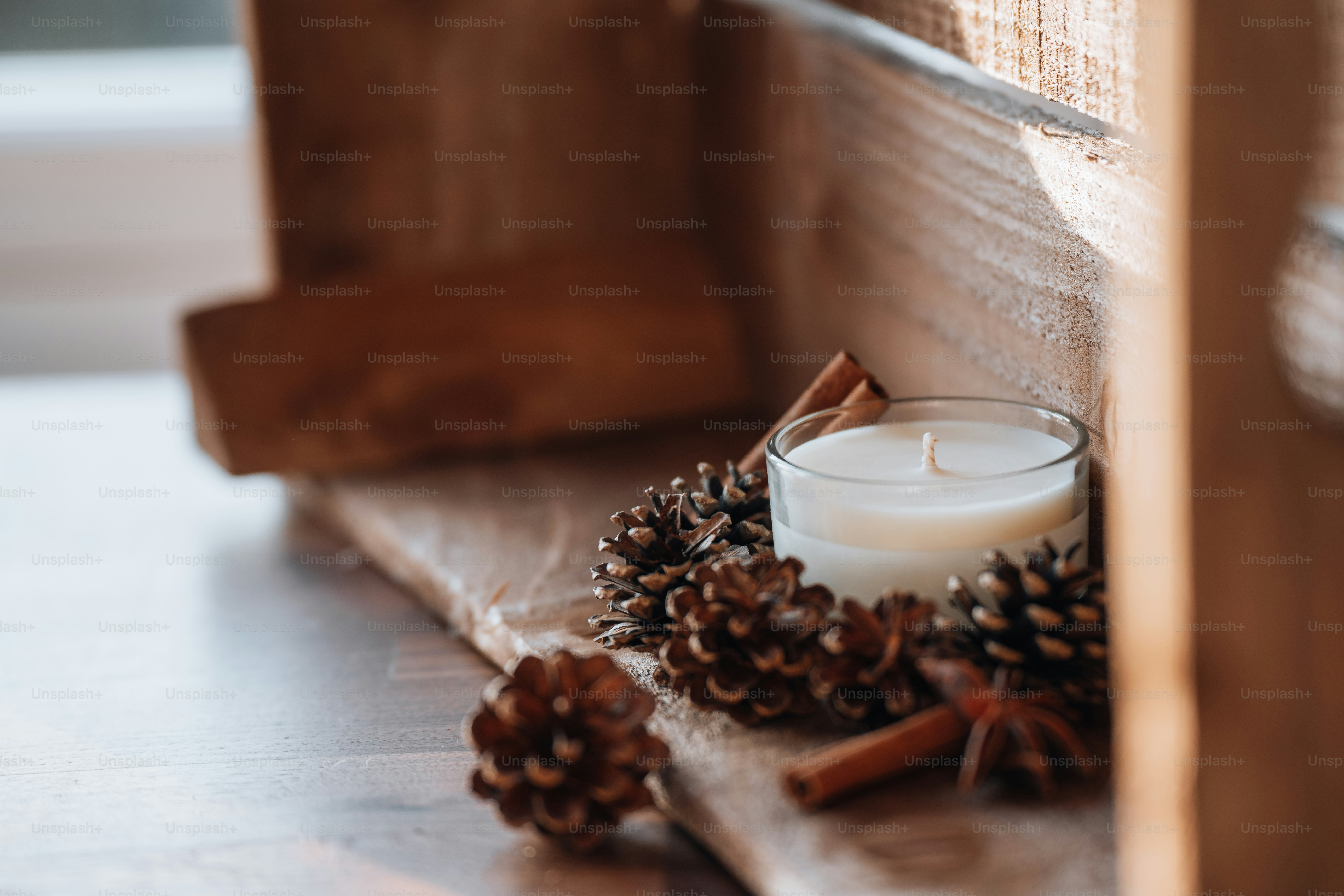 a candle and a bowl of nuts