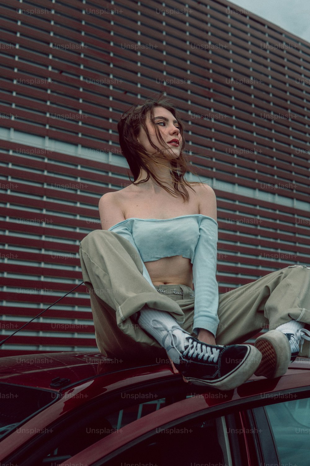 a woman sitting on a car